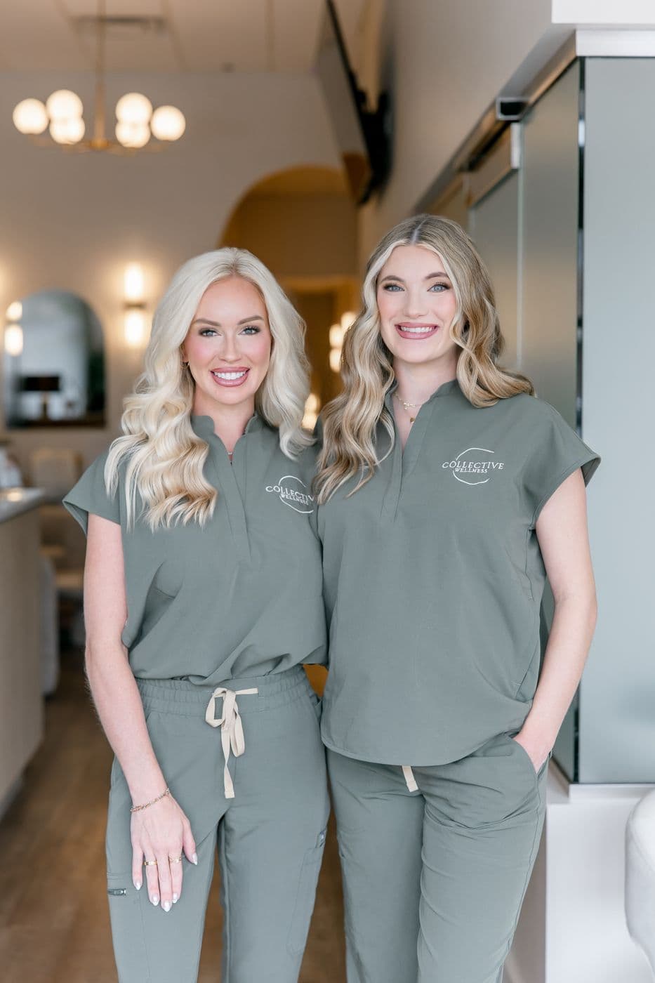 Two members of our team smiling in the clinic hallway